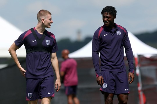 Adam Wharton and Kobbie Mainoo of England walk to a training session